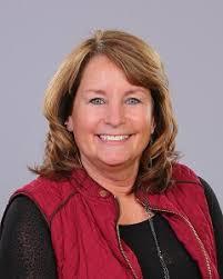 Sally Smith commissioner with red vest smiling